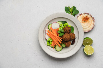 Vegan Buddha bowl with falafel, edamame beans, carrots, cucumber. Middle Eastern vegan healthy food concept