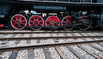 Details of drive mechanism and red wheels on railroad