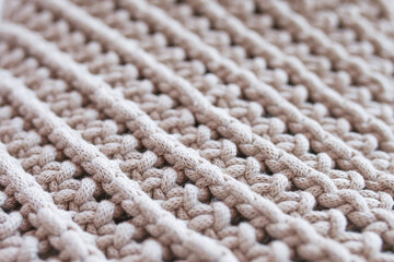 Fototapeta na wymiar Handmade macrame pattern close up. Macrame braiding and cotton threads. Female hobby. ECO friendly modern knitting 