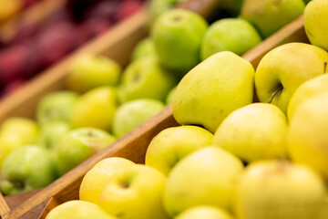 Showcase with various types of apples at supermarket