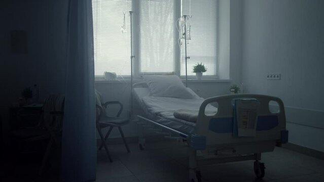 Empty clinic room interior with neat beds medical drips. Calm ward environment.