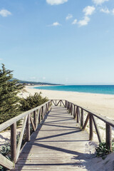 Fototapeta na wymiar Wood entrance to Paradise Beach in South of Spain.