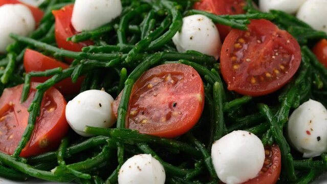 Fresh Samphire salad with cherry tomatoes and mozzarella. Healthy food. Rotating video