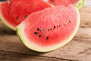 A bunch of red ripe watermelon on a wooden background