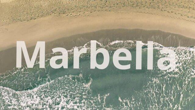 Marbella word being revealed with the shadow of a flying airplane on the beach