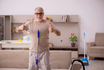 Old man doing housework at home