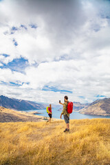 Fototapeta na wymiar Successful couple taking picture Lake Wakatipu South Island