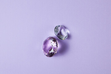 Purple precious gemstones for design gems jewellery. Big diamonds crystal on purple background.