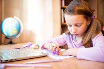 Young female distance teacher having video conference call with pupil using webcam. Online education and e-learning concept. Home quarantine, distance learning and working from home.