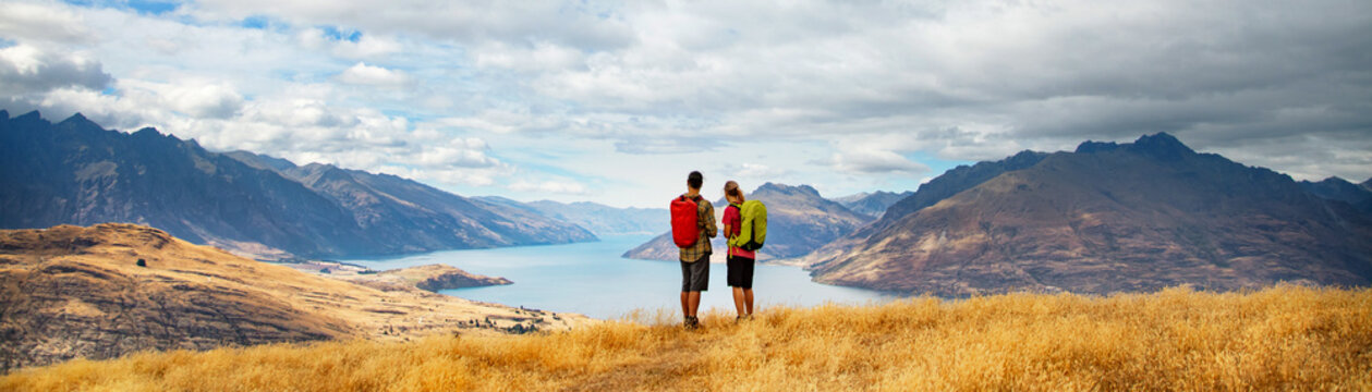Panorama of New Zealand adventure couple hiking The Remarkables Otago