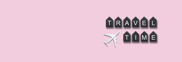 Traveling concept , wooden cubes with TRAVEL TIME words and airplane model