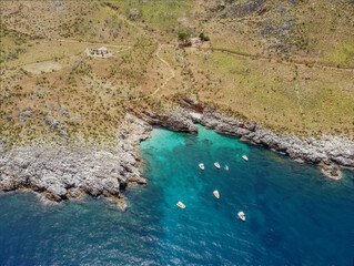Fototapeta na wymiar Drone aerial above beautiful coastline, turquoise clear sea water, wild nature, Zingaro Nature Reserve, Sicily. Tropical travel holiday near Scopello.