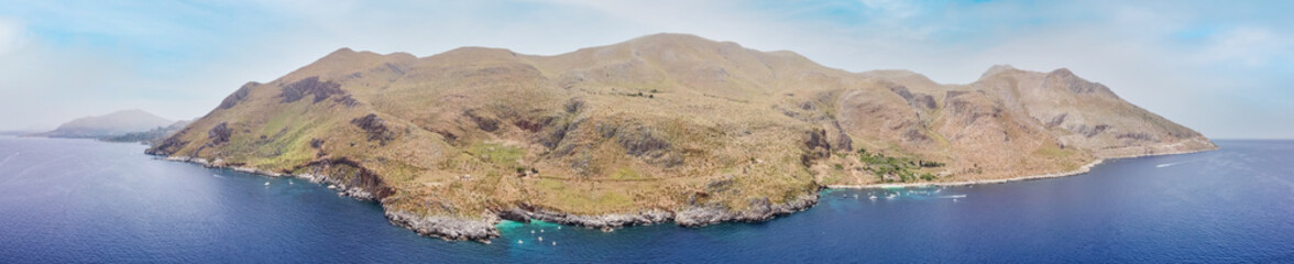 Drone aerial above beautiful coastline, turquoise clear sea water, wild nature, Zingaro Nature Reserve, Sicily. Tropical travel holiday near Scopello. - obrazy, fototapety, plakaty