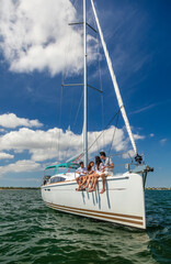 Latino family enjoying healthy outdoor vacation on yacht