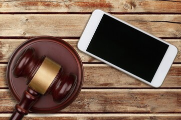 Blank screen seen on a smartphone and judge gavel.