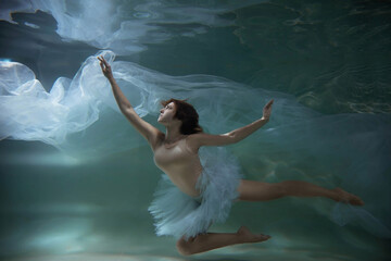 A girl under water in a tutu. like a jellyfish