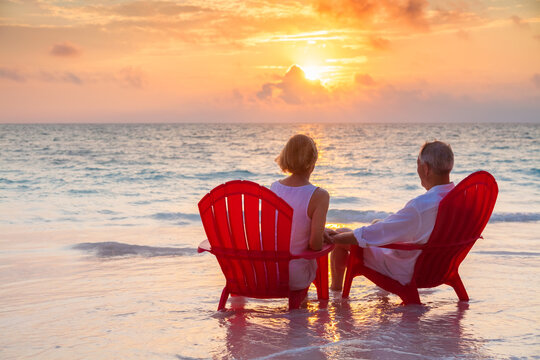 Retired couple enjoying sunset view over ocean Bahamas