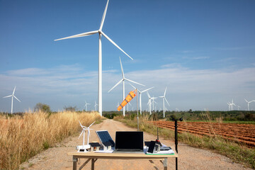Windturbine  Solar Cell model with wind measurement equipment on table front of huge wind turbine ,...
