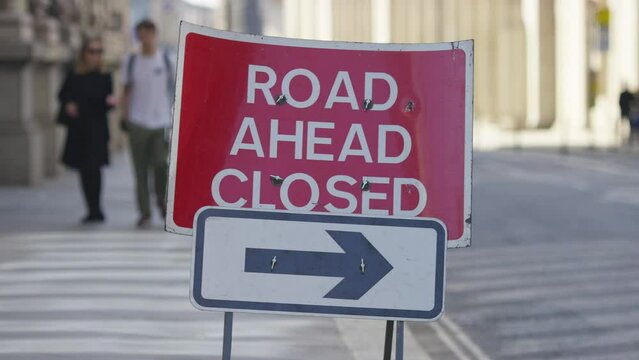 Static shot of a traffic sign saying the road ahead is closed