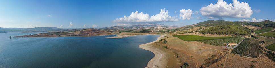 Aerial drone. Panoramic view at Fortino di Mazzallakkar, Arab fort in Sambuca di Sicilia, Sicily, on Lago Arancio. This area is well known for the production of grapes and white and red wine.