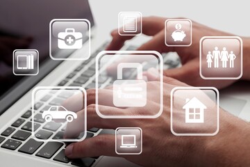 Businessman using a laptop computer to insurance online for car, travel, family and life, financial and health icon.