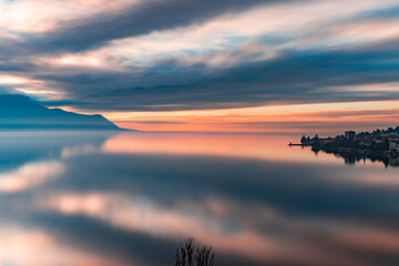 Reflex of the sky during beatiful sunset by the lake with the Alps in the background at Montreux Switzerland