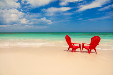 Red chairs with view of turquoise ocean Bahamas