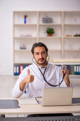 Young male doctor working in the clinic