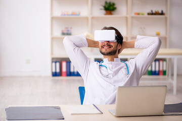 Young male doctor wearing virtual glasses