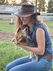 Cowgirl sitting with dog