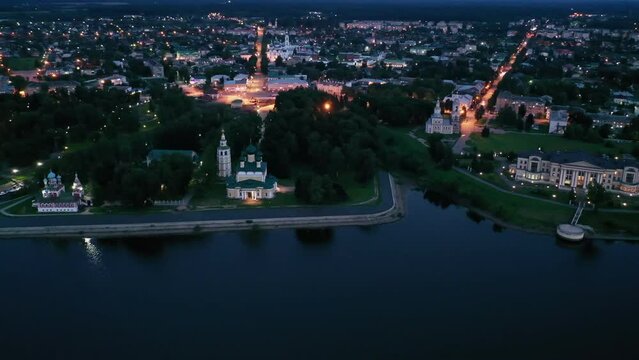Scenic general aerial view of lighted Russian town of Uglich on banks of Volga River on summer evening, Yaroslavl Oblast. High quality 4k footage