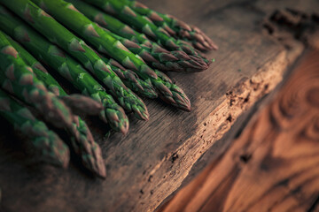 asparagus's tip on top of a old chopping board