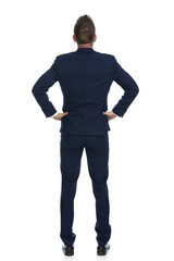 businessman putting his arms on his waist