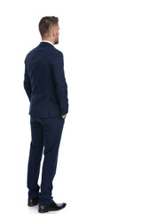 businessman waiting in line with his hands in pockets