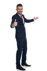handsome businessman gesturing it's ok, follow me