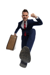 angry businessman kicking with his foot, feeling upset