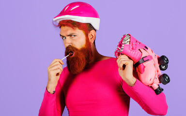 Man in helmet with roller skates and lollipop. Sports equipment. Active sport lifestyle. Vacation.