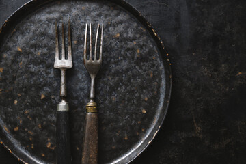 Vintage rustic cutlery on dark