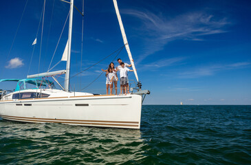 Luxury yacht with Hispanic family standing on bow