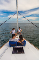 Hispanic family relaxing together on luxury private yacht