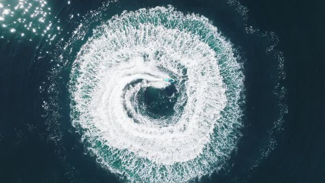 Jet skiing in open waters Aerial footage 4K top down Cinematic water background
