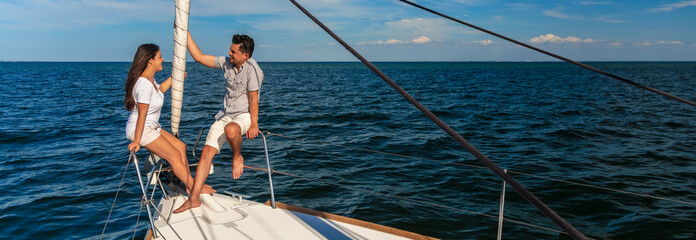 Panoramic Hispanic couple sitting together on private yacht