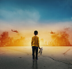 Child watches the destroyed city during the war