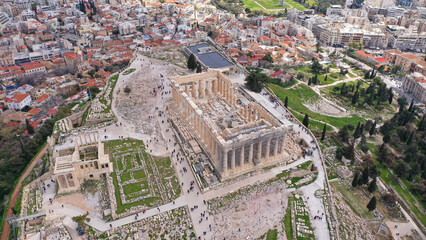 Aerial drone photo of unique Masterpiece of Ancient times the Parthenon on top of iconic Acropolis hill with cloudy sky, Athens, Attica, Greece