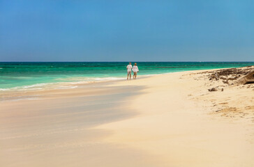 Romantic getaway for retired couple walking by ocean