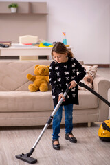 Young little girl doing housework at home