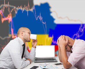 A failed investor emotion. Man sad and see in front of laptop with Ukraine and Russia flag.