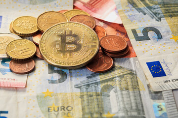 Bitcoin coin against euro cash background