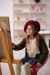 Young little girl enjoying painting at home