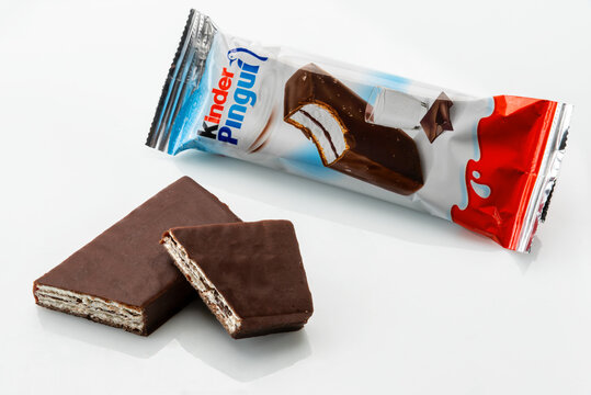 Alba, Italy - March 28, 2022: kinder Pingui Ferrero sponge cake snack filled with milk cream covered with chocolate, produced by Ferrero important confectionery factory in the world